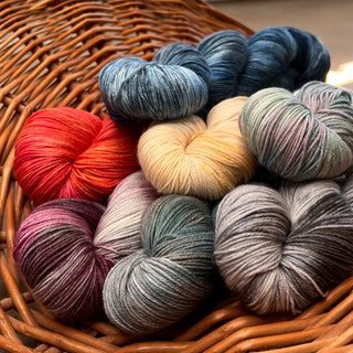 basket of Dory Sock alpaca yarn in various colours