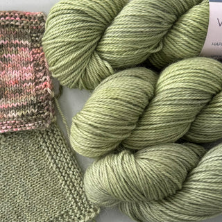Skeins of Valley Purl Sport weight yarn in colour Ticklegrass