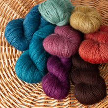 Load image into Gallery viewer, Basket of hand-dyed Lady Slipper fingering weight alpaca yarns from Green Gable Alpacas.
